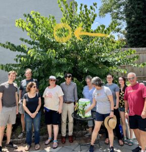 Group of neighbors with released butterfly in the tree above